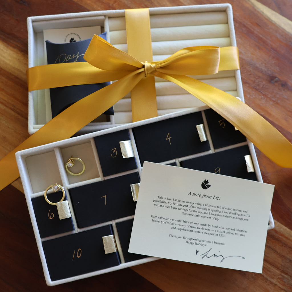 Jewelry set with yellow ribbon in a box on a wooden surface
